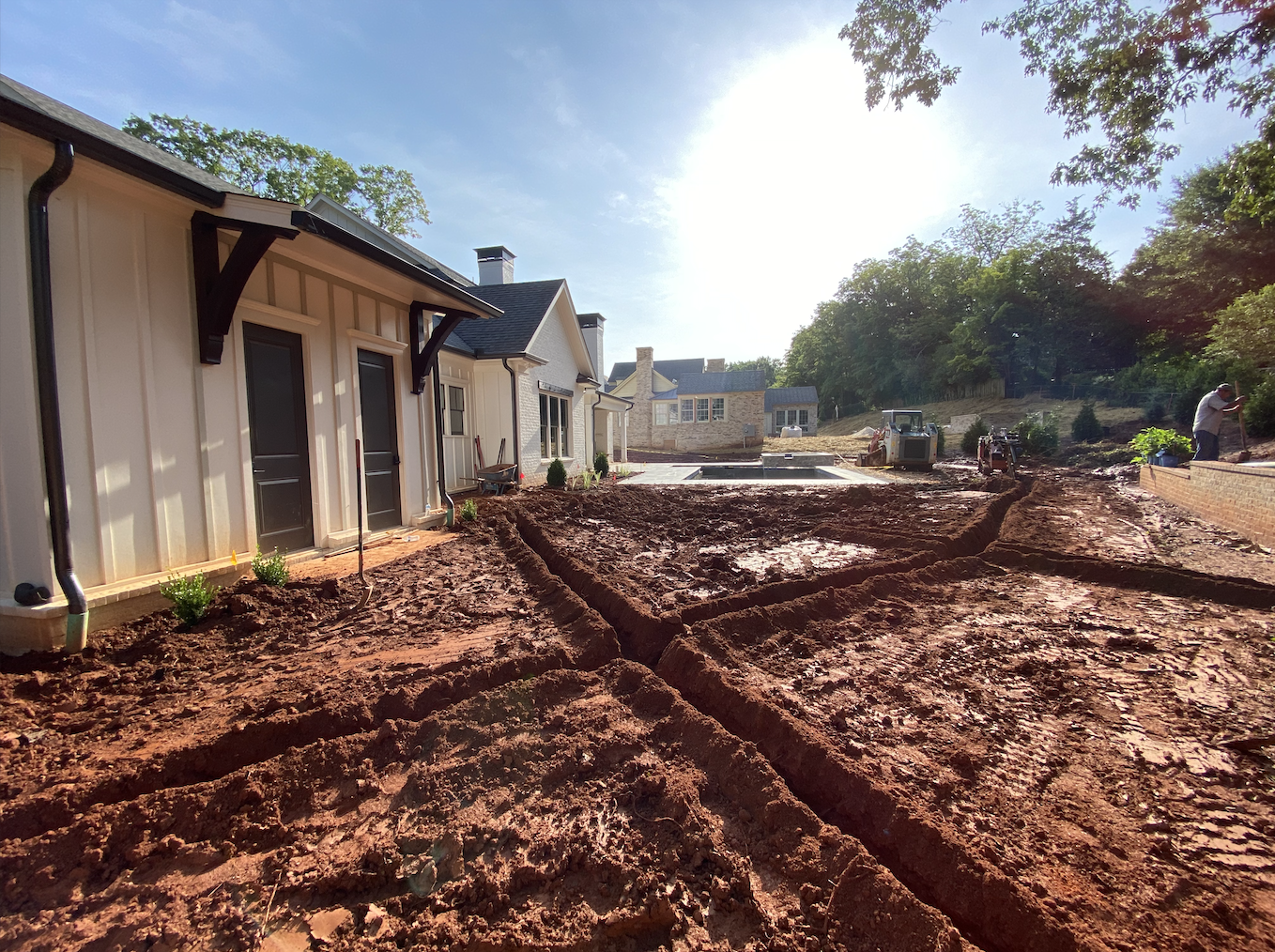 A house with a dirt road being constructed in front